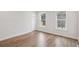 Bright, empty bedroom with laminate flooring, two windows and white trim at 512 9Th Ave. S, North Myrtle Beach, SC 29582