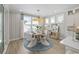 Elegant dining room with a round table, modern chairs, large windows, and stylish light fixture at 512 9Th Ave. S, North Myrtle Beach, SC 29582