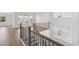 Open hallway with hardwood floors, stylish railing, and large windows offering abundant natural light at 512 9Th Ave. S, North Myrtle Beach, SC 29582