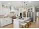 Gourmet kitchen featuring white cabinetry, stainless appliances, a center island with seating, and pendant lights at 512 9Th Ave. S, North Myrtle Beach, SC 29582