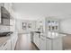 Bright kitchen featuring stainless steel sink, white cabinets, and views of the dining area at 512 9Th Ave. S, North Myrtle Beach, SC 29582