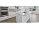 Modern kitchen with stainless steel appliances, white cabinets, and a large center island at 512 9Th Ave. S, North Myrtle Beach, SC 29582