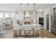 Bright kitchen with white cabinets, stainless steel appliances, an island with seating, and pendant lighting at 512 9Th Ave. S, North Myrtle Beach, SC 29582
