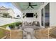 Relaxing outdoor living space with a fire pit, comfortable seating, and mounted TV at 512 9Th Ave. S, North Myrtle Beach, SC 29582