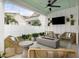 Inviting covered patio with comfortable seating, a modern fireplace, and a ceiling fan at 512 9Th Ave. S, North Myrtle Beach, SC 29582