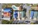 Aerial view of colorful homes featuring matching metal roofs and verdant landscaping at 514 Vallecrosia Ct., Little River, SC 29566