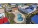 Aerial view of a community pool surrounded by colorful homes with palm trees at 514 Vallecrosia Ct., Little River, SC 29566