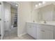 Bathroom featuring double vanity, white cabinetry and view into tub/shower at 514 Vallecrosia Ct., Little River, SC 29566