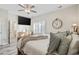 Bright bedroom featuring hardwood floors, ceiling fan, plantation shutters and a bathroom en suite at 514 Vallecrosia Ct., Little River, SC 29566