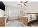 Bright bedroom featuring hardwood floors, ceiling fan, plantation shutters and a bathroom en suite at 514 Vallecrosia Ct., Little River, SC 29566