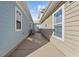 A private side yard with well-maintained siding and an outdoor grill at 514 Vallecrosia Ct., Little River, SC 29566