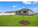 Expansive backyard featuring lush green grass and a charming home with a screened porch at 515 Goldstar St., Conway, SC 29526