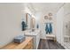 Bright bathroom features a double sink vanity, framed mirrors, and a walk-in shower with a glass door at 515 Goldstar St., Conway, SC 29526