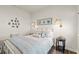 Cozy bedroom featuring a beautifully decorated queen size bed, wooden floor, and natural light from the window at 515 Goldstar St., Conway, SC 29526