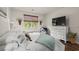 Comfortable bedroom with a beautifully decorated queen size bed, wooden floor, and natural light from the window at 515 Goldstar St., Conway, SC 29526