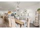 Dining area featuring a wood table, wicker chairs, and an open view of the modern kitchen at 515 Goldstar St., Conway, SC 29526