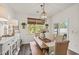 Bright dining room with rustic table, woven chairs, stylish chandelier, and sliding door to the patio at 515 Goldstar St., Conway, SC 29526