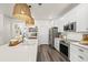 Bright kitchen featuring white cabinets, stainless steel appliances, large island with sink and stylish pendant lighting at 515 Goldstar St., Conway, SC 29526