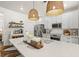 Bright kitchen featuring white cabinets, stainless steel appliances, large island with sink and stylish pendant lighting at 515 Goldstar St., Conway, SC 29526