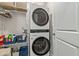 Bright laundry room with stacked washer and dryer, wire shelving, and storage space at 515 Goldstar St., Conway, SC 29526