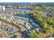 Aerial view of colorful homes, a pond, manicured landscaping, and the Intracoastal Waterway in the background at 5223 Sea Coral Way, North Myrtle Beach, SC 29582