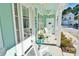 Cozy front porch with ceiling fans and comfortable seating, perfect for relaxing outdoors at this coastal home at 5223 Sea Coral Way, North Myrtle Beach, SC 29582