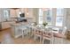 Eat-in kitchen features granite counters, breakfast bar, and white cabinetry at 5223 Sea Coral Way, North Myrtle Beach, SC 29582