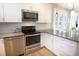Updated kitchen with stainless appliances, white cabinets, and granite counters at 5223 Sea Coral Way, North Myrtle Beach, SC 29582