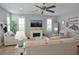 Comfortable living room with coastal decor, fireplace, and a ceiling fan enhancing the inviting atmosphere at 5223 Sea Coral Way, North Myrtle Beach, SC 29582