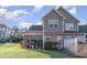 Charming backyard featuring a screened-in porch, lush green lawn, and privacy fence at 611 Indigo Bunting Ln. # 42 E, Murrells Inlet, SC 29576