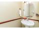 Simple bathroom featuring a pedestal sink, oval mirror, and decorative accents at 611 Indigo Bunting Ln. # 42 E, Murrells Inlet, SC 29576