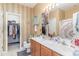 Bathroom features a double vanity, tiled floor, and a separate walk-in closet, providing ample storage at 611 Indigo Bunting Ln. # 42 E, Murrells Inlet, SC 29576
