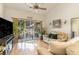 Bright living room featuring hardwood floors, vaulted ceilings, neutral paint, and sliding door to patio at 611 Indigo Bunting Ln. # 42 E, Murrells Inlet, SC 29576