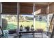 Cozy screened porch with seating, table, and lovely community views at 611 Indigo Bunting Ln. # 42 E, Murrells Inlet, SC 29576