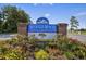 The Myrtle Beach Golf & Yacht Club community sign is framed with flowers, offering a warm welcome at 6850 Blue Heron Blvd. # 205, Myrtle Beach, SC 29588