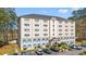 An exterior view of the building in a well-maintained community with manicured landscaping at 6850 Blue Heron Blvd. # 205, Myrtle Beach, SC 29588