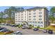 Exterior view of the building in a well-maintained community with ample parking at 6850 Blue Heron Blvd. # 205, Myrtle Beach, SC 29588