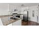 Kitchen features white cabinets, granite countertops, and stainless steel appliances at 6850 Blue Heron Blvd. # 205, Myrtle Beach, SC 29588