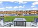 A waterfront backyard view with a lake view and patio seating with a stone firepit at 7205 Spoleto Dr., Myrtle Beach, SC 29572