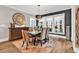 Open dining room features a stylish light fixture, large windows, and hardwood floors at 7205 Spoleto Dr., Myrtle Beach, SC 29572