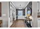 Elegant foyer features unique wallpaper, wood floors, a decorative mirror, and a stylish pendant light at 7205 Spoleto Dr., Myrtle Beach, SC 29572