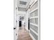 Bright hallway with a modern sliding door and wood flooring leading to a bedroom at 7205 Spoleto Dr., Myrtle Beach, SC 29572