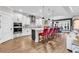 Modern kitchen featuring white cabinets, a spacious island with bar seating, and stainless steel appliances at 7205 Spoleto Dr., Myrtle Beach, SC 29572