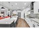 Bright kitchen features white cabinets, stainless appliances, island with a farmhouse sink, and stylish backsplash at 7205 Spoleto Dr., Myrtle Beach, SC 29572