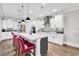 Stylish kitchen with white cabinetry, pendant lighting, a large island with seating, and a decorative backsplash at 7205 Spoleto Dr., Myrtle Beach, SC 29572