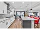 Bright kitchen featuring a large island with seating, white cabinets, stainless steel appliances, and an open floor plan at 7205 Spoleto Dr., Myrtle Beach, SC 29572