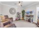 Cozy living room with a comfortable recliner, neutral carpet, and a view of the home's front exterior at 7205 Spoleto Dr., Myrtle Beach, SC 29572