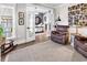 Comfortable living room with plush seating, neutral carpet, and a rocking horse next to a window at 7205 Spoleto Dr., Myrtle Beach, SC 29572