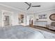 Well-lit bedroom featuring a ceiling fan, a wall-mounted television, and comfortable seating at 7205 Spoleto Dr., Myrtle Beach, SC 29572