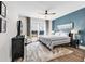 Comfortable bedroom with a large window, ceiling fan, and stylish furniture at 7205 Spoleto Dr., Myrtle Beach, SC 29572